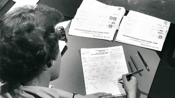 student writing on paper