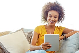 woman reading on tablet.