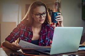 woman studying and drinking coffee.