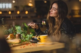 Woman sitting at a table eating dinner