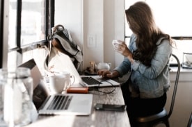 woman sitting in cafe working on laptop.