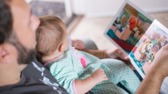 dad reading to his baby
