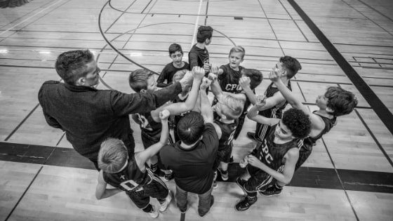 Coach, cheering with his basketball team