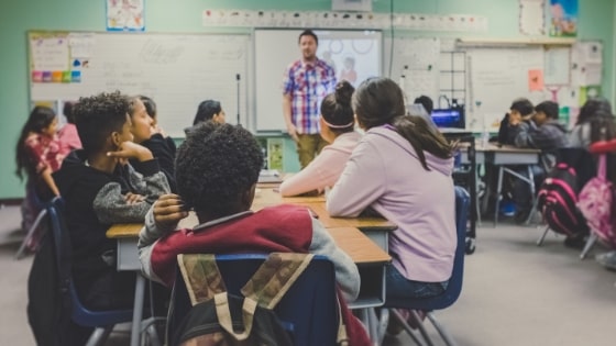 Teacher lecturing a middle school class