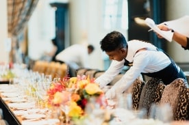 man setting up for event in hotel.