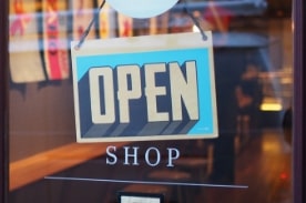 blue and white open on shop door.