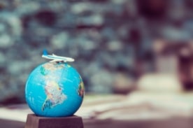 model plane sitting on a globe.