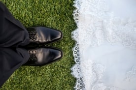 bride and groom on grass