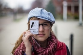 girl hold card that reads dare to dream